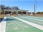 View larger image of Shuffleboard courts with white benches at TOPICS RV RESORT image #3