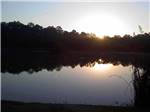A view of the lake at dusk at OAK PLANTATION CAMPGROUND - thumbnail