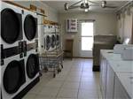 Washers, driers and rolling baskets in laundry room at TRIPLE 'J' RV PARK - thumbnail