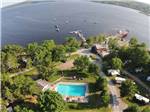 Aerial view of beautiful pool, woods, and lake with boats at HARDINGS POINT CAMPGROUND - thumbnail