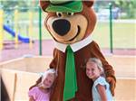 Two young girls standing with Yogi Bear at JELLYSTONE PARK AT MAMMOTH CAVE - thumbnail