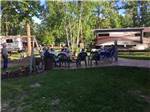 People sitting around a fire pit at ROYAL OAKS RV PARK - thumbnail