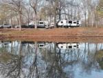 Reflection of RVs in the water at Arrowhead Point RV Park & Campground - thumbnail