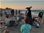 A man dressed as a pirate talking to guest on the beach at CAMP HATTERAS RV RESORT & CAMPGROUND - thumbnail