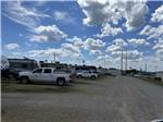 White clouds and a blue sky over the RV sites at OVERLAND RV PARK - thumbnail