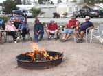Campers sitting around a fire pit - thumbnail