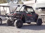 Two ATVs parked in a gravel spot - thumbnail