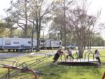 Children playing on the merry-go-round at THE OUACHITA RV PARK - thumbnail