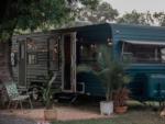 Travel trailers at a site with plants at THE OUACHITA RV PARK - thumbnail