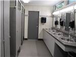 Bathroom with tiled floor and walls and stalls at GORDON HOWE CAMPGROUND - thumbnail
