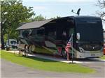 Motorhome in a paved RV site at MOCKINGBIRD HILL RV PARK - thumbnail