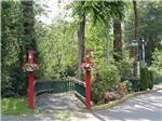 View larger image of Two red posts leading to a walkway at COTTONWOOD MEADOWS RV COUNTRY CLUB image #1