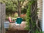 Outdoor chairs near trees and flowers at LAZY DAY CAMPGROUND - thumbnail