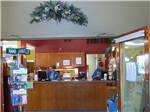 Front desk with wreath above clerk at DAKOTA RIDGE RV RESORT - thumbnail