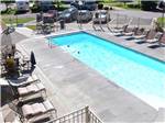 Long rectangular pool surrounded by chaise lounges at DAKOTA RIDGE RV RESORT - thumbnail