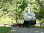 Trailer in a gravel site at WHISPERING PINES CAMPGROUND & RV PARK - thumbnail