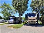 View larger image of Motorhomes parked in gravel sites at DADS BLUEGRASS CAMPGROUND image #1