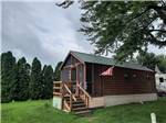 A wooden cabin with a deck at SHIPSHEWANA CAMPGROUND SOUTH PARK - thumbnail
