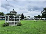 A white gazebo with chairs at SHIPSHEWANA CAMPGROUND SOUTH PARK - thumbnail