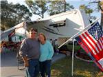 View larger image of Couple camping at ROSE BAY TRAVEL PARK image #6