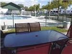View larger image of A table outside of the swimming pool area at SONRISE PALMS RV PARK image #4