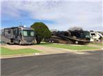 View larger image of A row of paved RV sites at CAMELOT VILLAGE RV PARK image #6