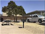 View larger image of An RV site with a picnic bench at CAMELOT VILLAGE RV PARK image #8