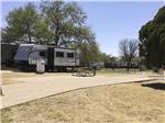 View larger image of A paved RV site with a picnic bench at CAMELOT VILLAGE RV PARK image #9