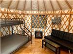 View larger image of A bunk bed and sofa inside the yurt at TILLAMOOK BAY CITY RV PARK image #9