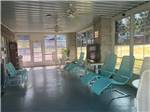 Teal lounge chairs in a sun room at Shipshewana Campground North Park & Amish Log Cabin Lodging - thumbnail