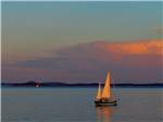 A sailboat on the ocean at sunset - thumbnail