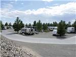 View larger image of Two people in an ATV passing RVs in their sites at ELEPHANT BUTTE LAKE RV RESORT image #4