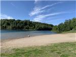 View larger image of The shoreline by the water at SHERWOOD FOREST CAMPGROUND image #1