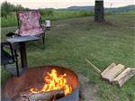 View larger image of A chair sitting next to a fire at SHERWOOD FOREST CAMPGROUND image #10