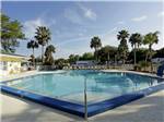 View larger image of Swimming pool with outdoor seating at CRYSTAL ISLES RV PARK image #5