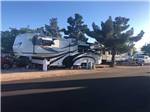 View larger image of Fifth wheel in campsite under blue sky at ZUNI VILLAGE RV PARK image #12