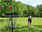 View larger image of A person playing Frisbee golf at QUILLYS MAGNOLIA RV PARK image #9
