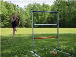 View larger image of A woman playing ladder ball at QUILLYS MAGNOLIA RV PARK image #10