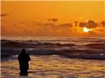View larger image of Man fishing at sunset at PACIFIC DUNES RANCH RV RESORT image #5
