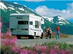 View larger image of A man taking a photo of a family at ANCHORAGE SHIP CREEK RV PARK image #1