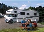 View larger image of A group of people sitting at a picnic table at ANCHORAGE SHIP CREEK RV PARK image #7