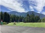A group of picnic tables in a grassy field at MOUNTAIN MEADOW RV PARK & CABINS - thumbnail