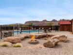 Fire pit with pool in the background at Sun Outdoors Canyonlands Gateway - thumbnail