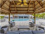 A covered seating area by the pool - thumbnail