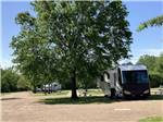 View larger image of A motorhome parked under a tree at AMERISTAR CASINO  RV PARK image #6