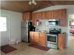 View larger image of Kitchen area inside cabin at SUNDANCE RV PARK image #2