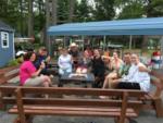 Group of people eating ice cream around a fire pit at Royal Mountain Campground - thumbnail