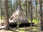 A teepee on a raised platform at FORT WELIKIT FAMILY CAMPGROUND - thumbnail