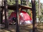 A tent under one of the covered tent sites at FORT WELIKIT FAMILY CAMPGROUND - thumbnail