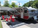 A travel trailer set up for camping at CREEKSIDE RV PARK - thumbnail